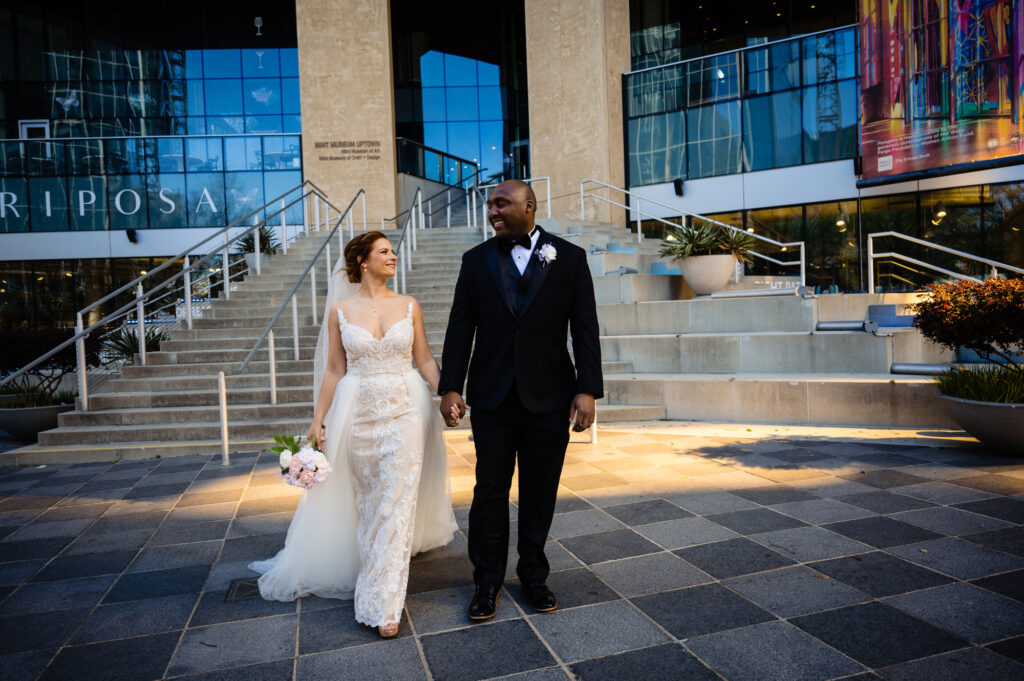 bride and groom walking outside of the mint museum in uptown charlotte north carolina