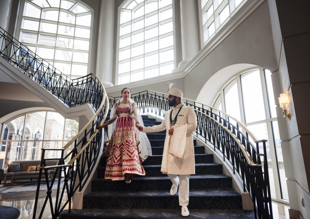 Bride and Groom walking down a staircase at the Ballantyne Hotel in Charlotte North Carolina