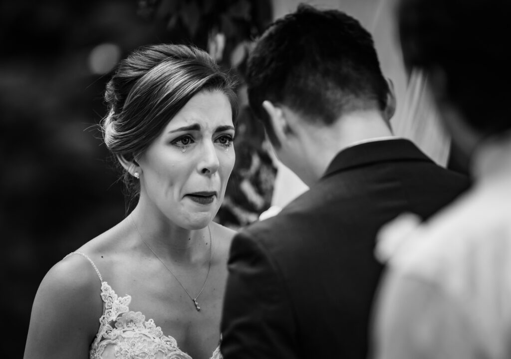 bride tearing up during a ceremony