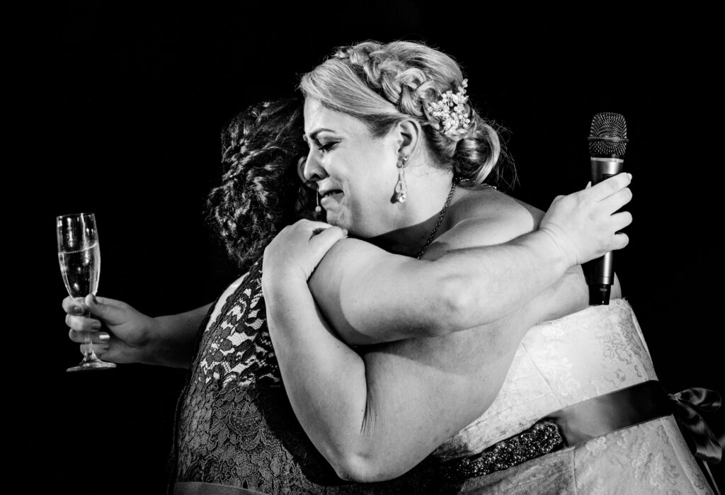 bride and mother share a hug in a wedding