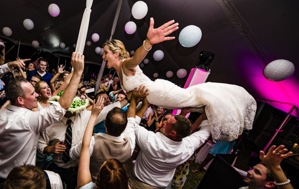 Bride does a crowed dive in a wedding reception