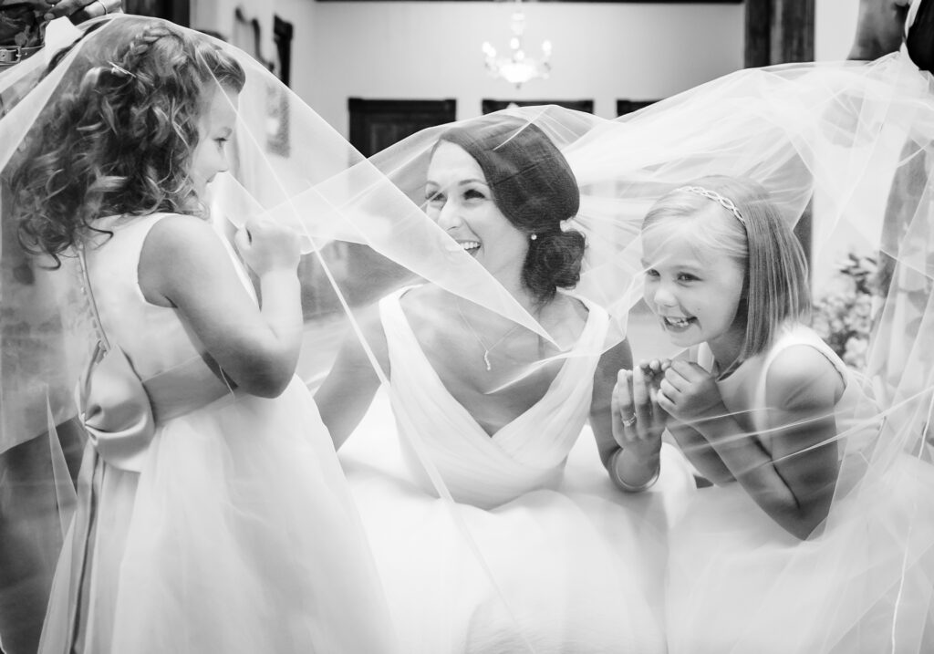 bride laughs with flower girls