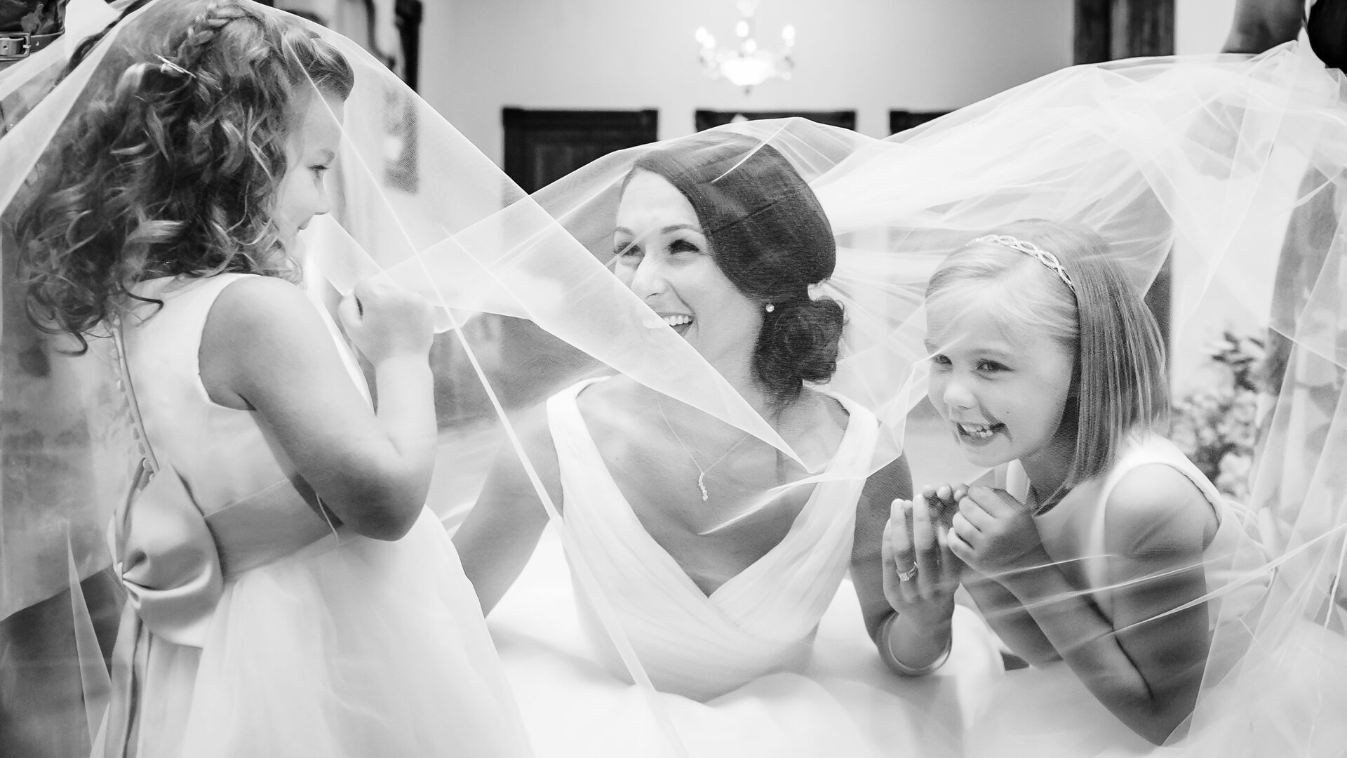 bride laughs with flower girls