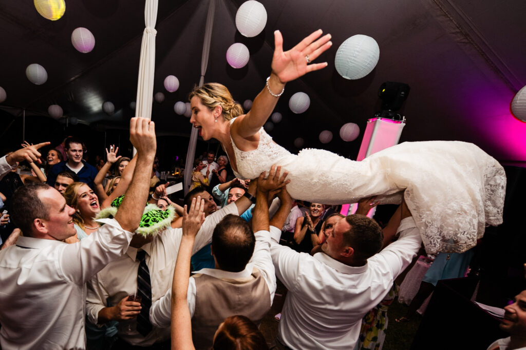 bride does a crowed dive at a wedding reception